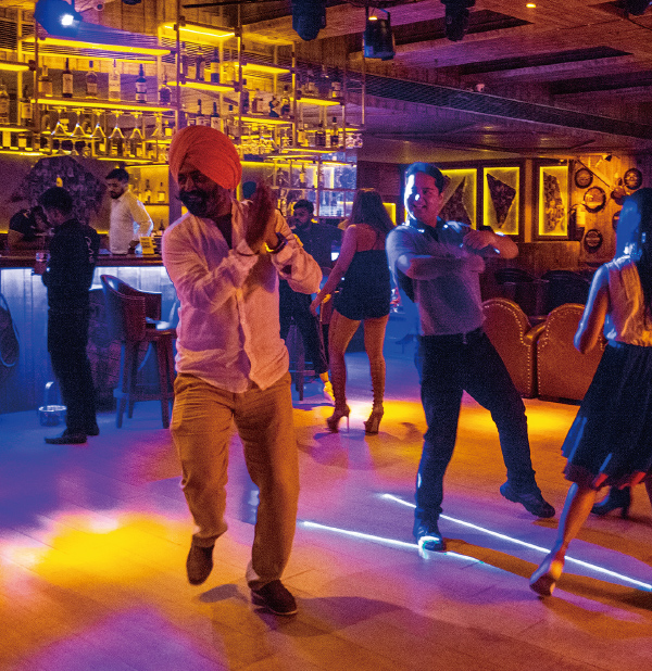 Hombre con turbante en la cabeza bailando en un club.